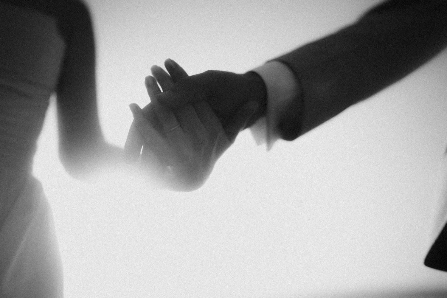 elopement couple holding hands close up on the beach in portugal