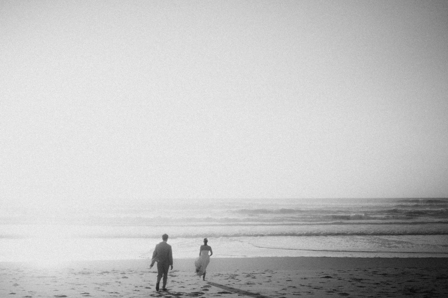 elopement couple walking on the beach in portugal