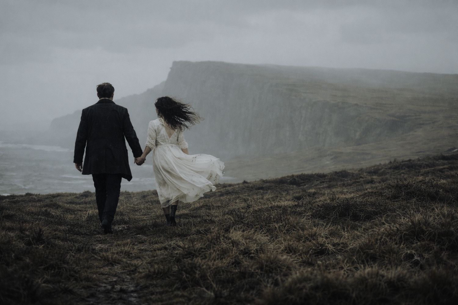 scotland elopement couple walking toward cliffs