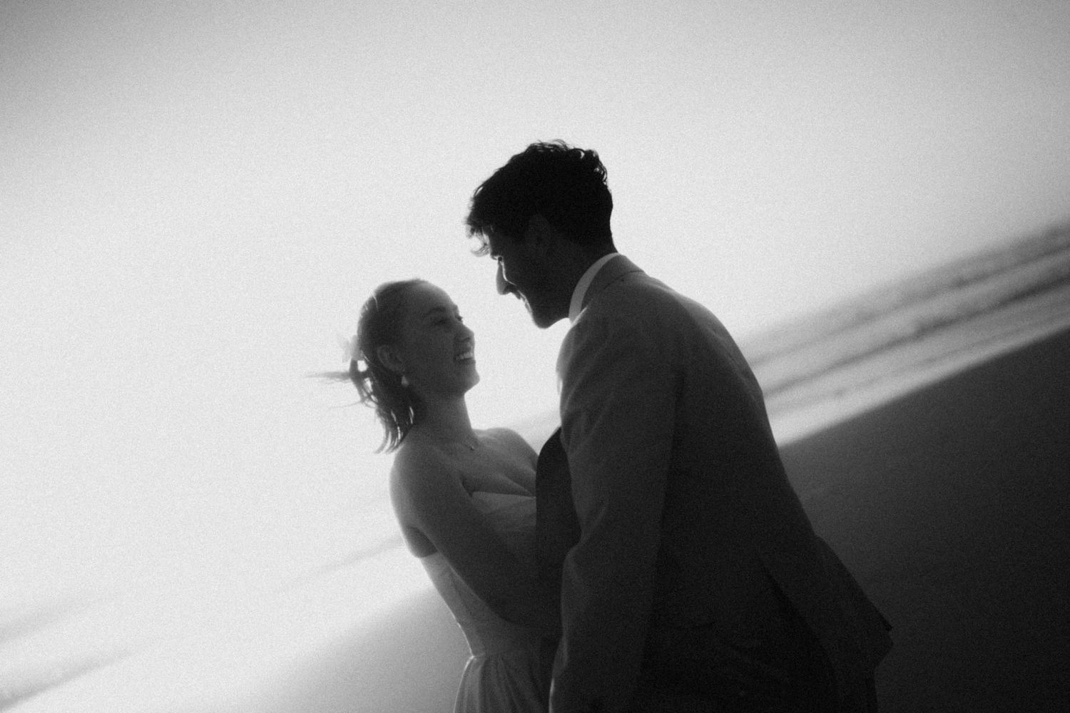 elopement couple intimate moment on the beach in lisbon portugal
