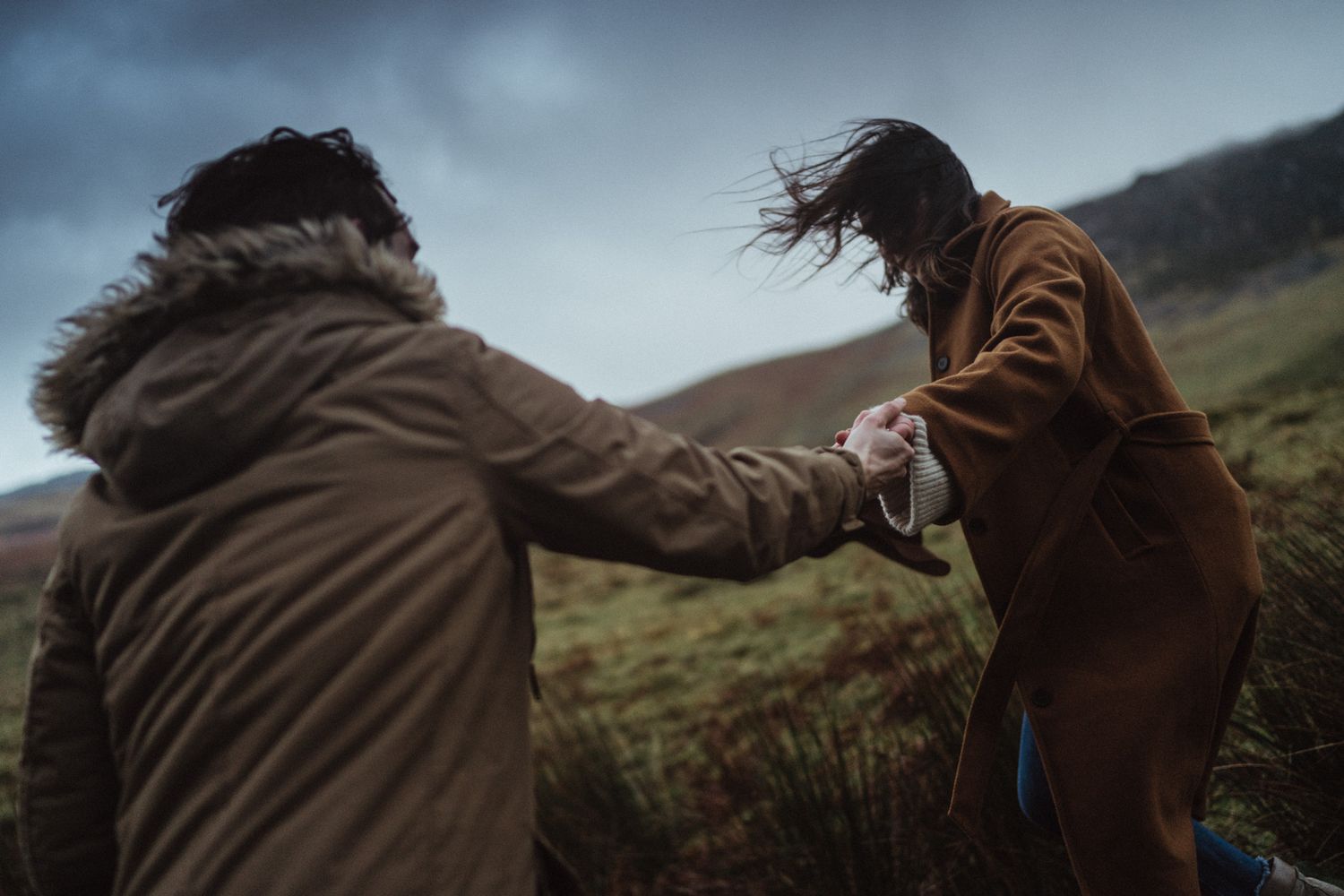 Portugal wedding photographer capturing an intimate elopement moment, couple holding hands in a wild natural landscape
