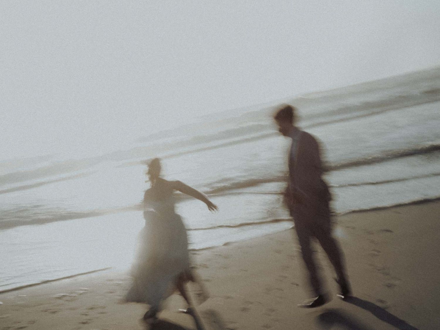 wedding couple walking by the ocean in portugal