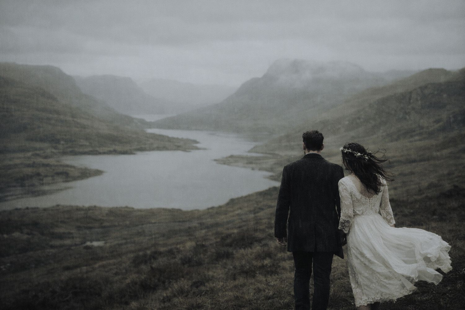 elopement in scotland couple walking through highlands landscape