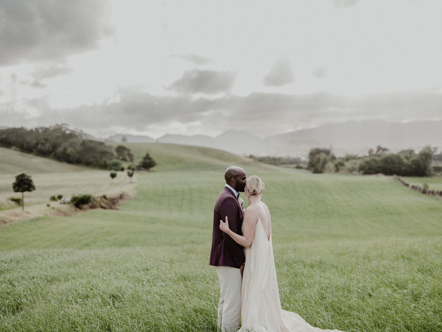Intimate Portugal elopement — couple kissing in scenic mountain landscape with soft romantic light