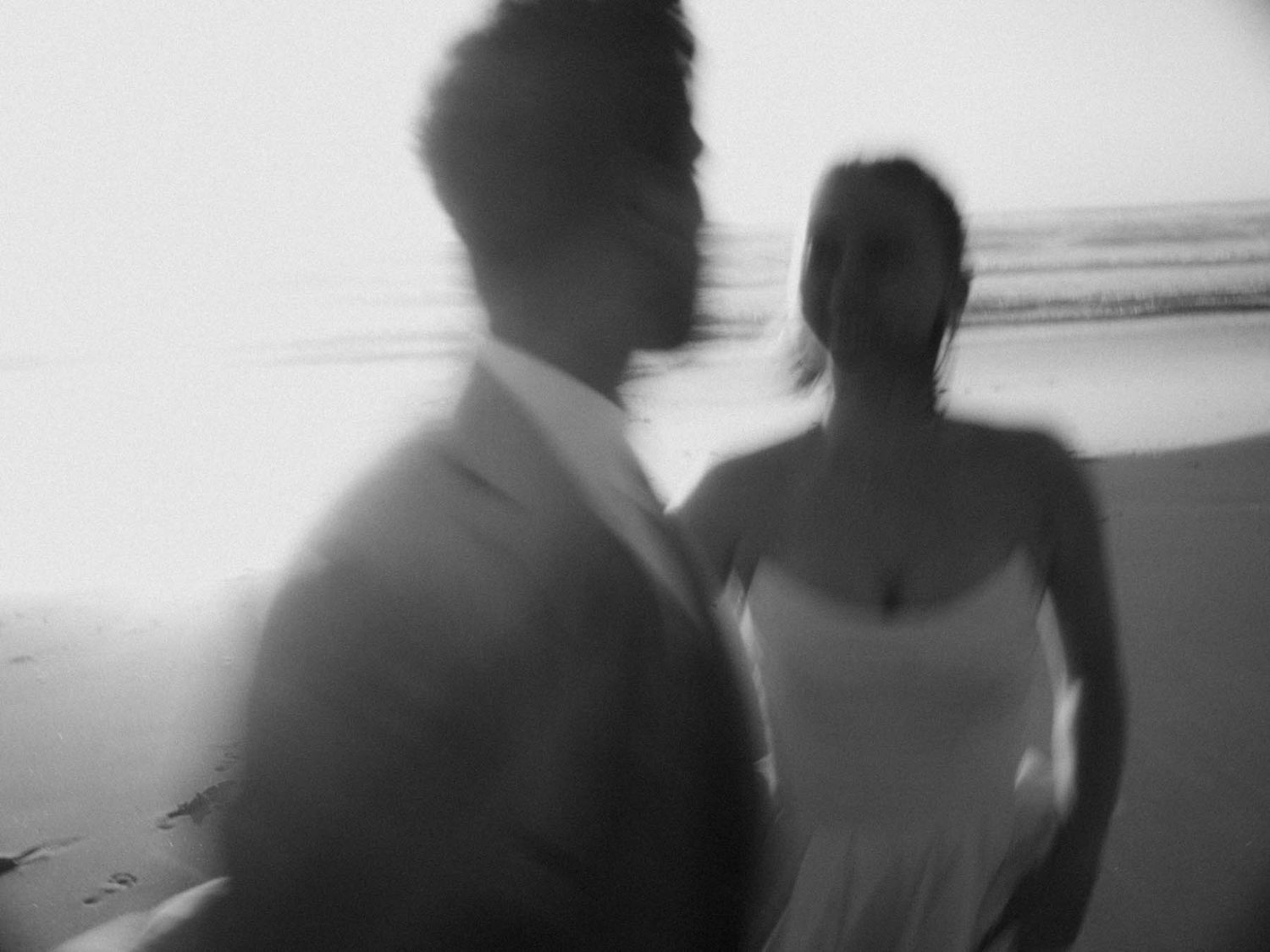elopement couple walking together on the beach in portugal