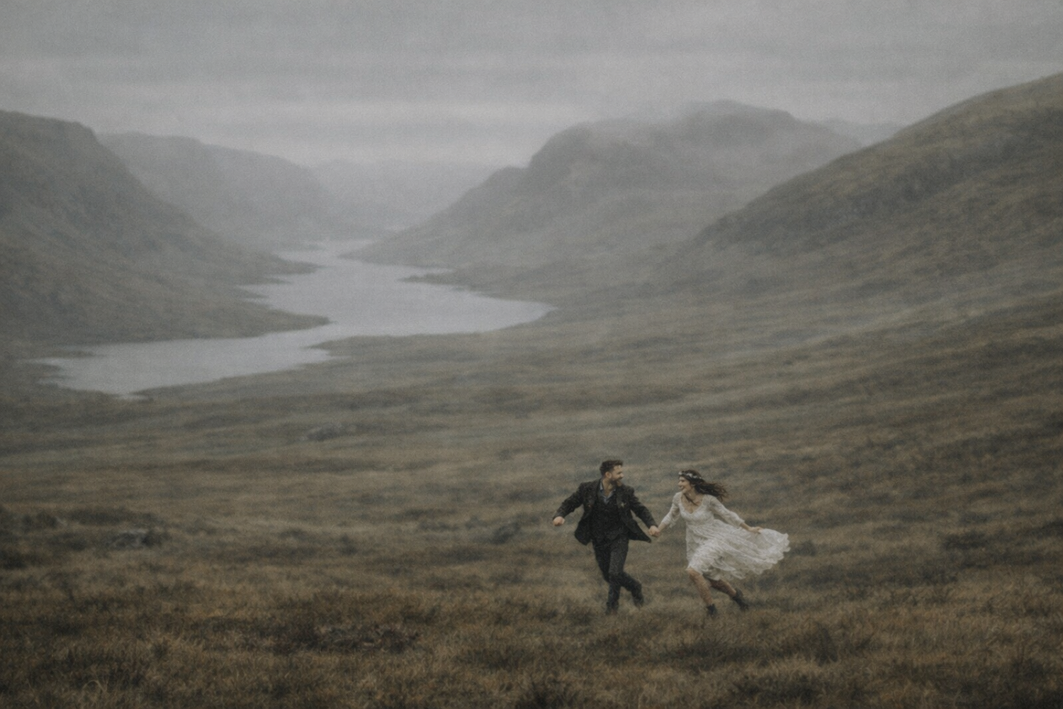 elopement in scotland couple running through valley