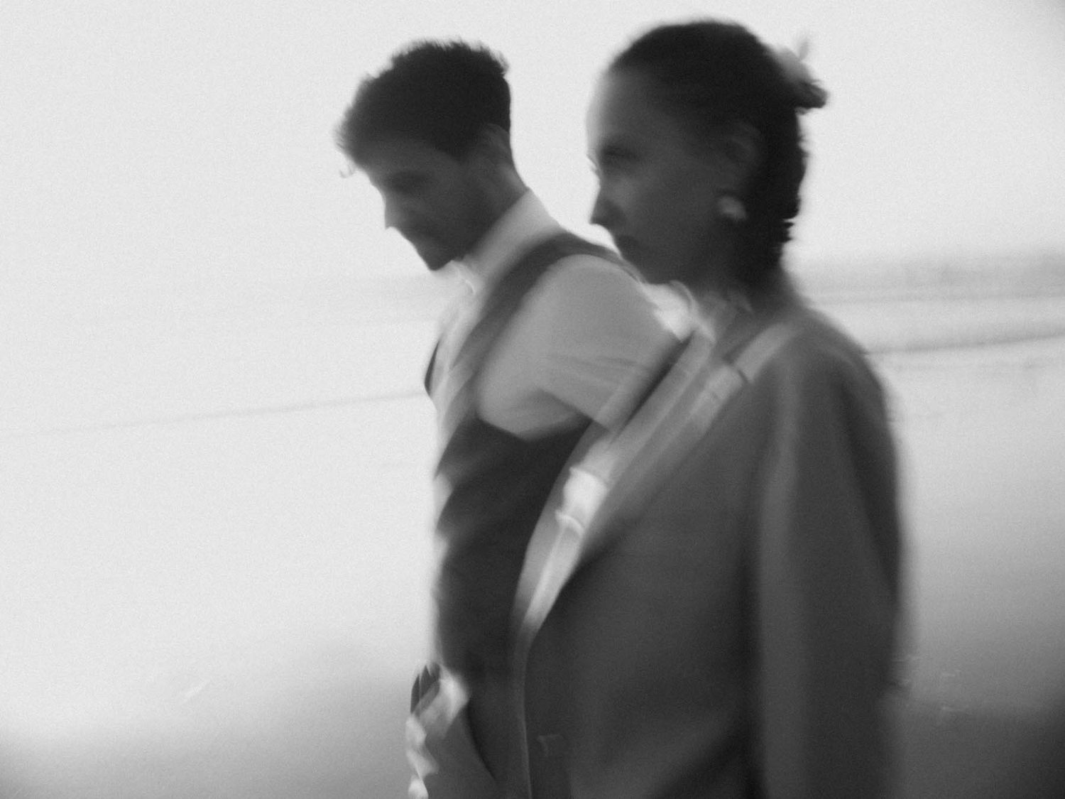 elopement couple walking along the beach in portugal