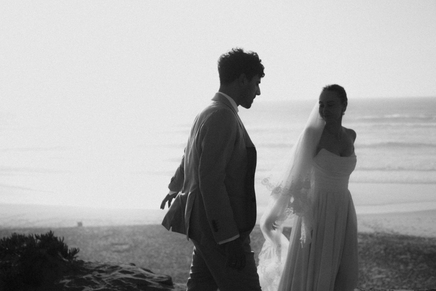 elopement couple interacting on the beach in portugal