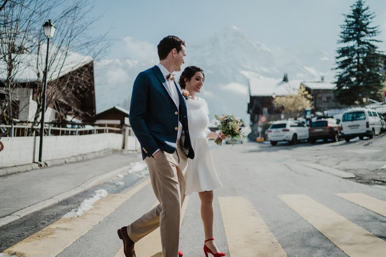 Alps elopement in Switzerland — stylish couple walking near the mountains captured by destination wedding photographers