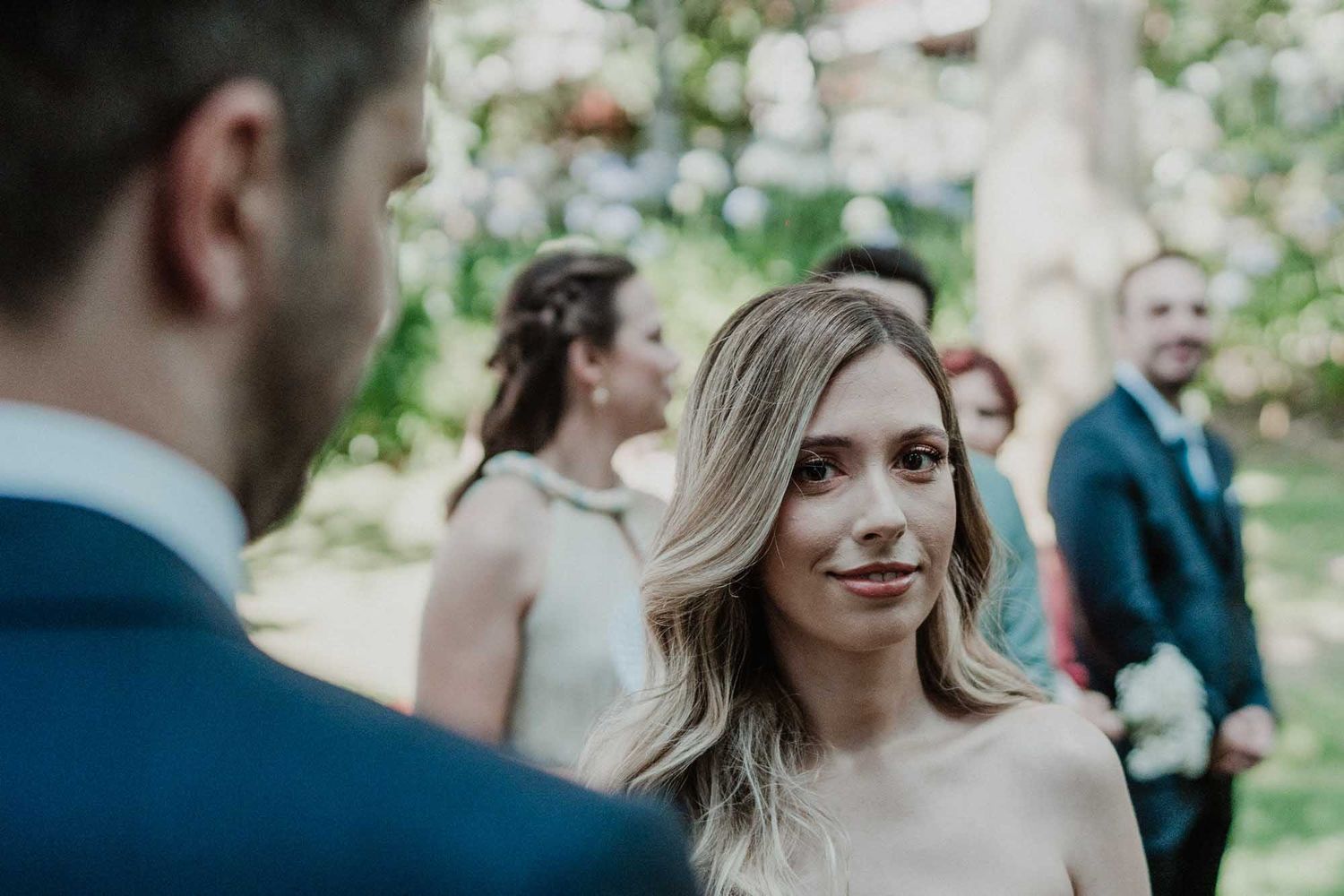 bride looking at groom during outdoor wedding ceremony in portugal