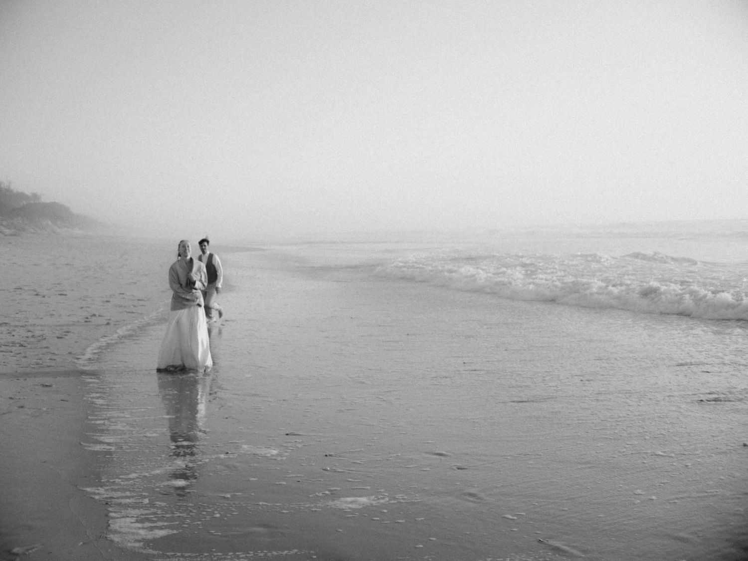 elopement couple standing on the shoreline near lisbon portugal
