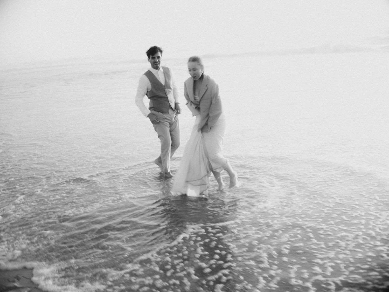 elopement couple walking in the ocean near lisbon portugal