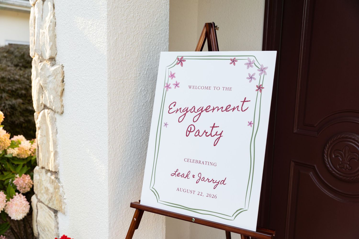 Elegant engagement party welcome sign on easel celebrating Deah and Jarayed at outdoor venue entrance.