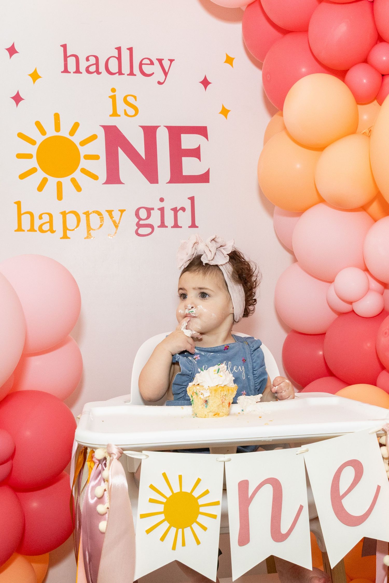 Baby girl smashing birthday cake at Hadley is ONE happy girl themed party.