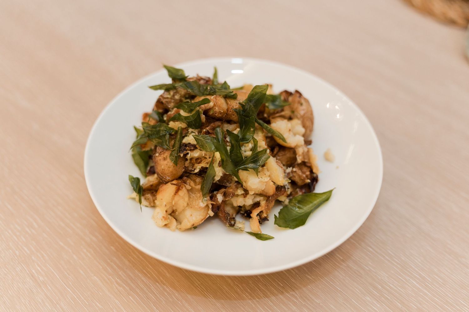 Asian stir fry dish with green beans and mushrooms served on a white plate.