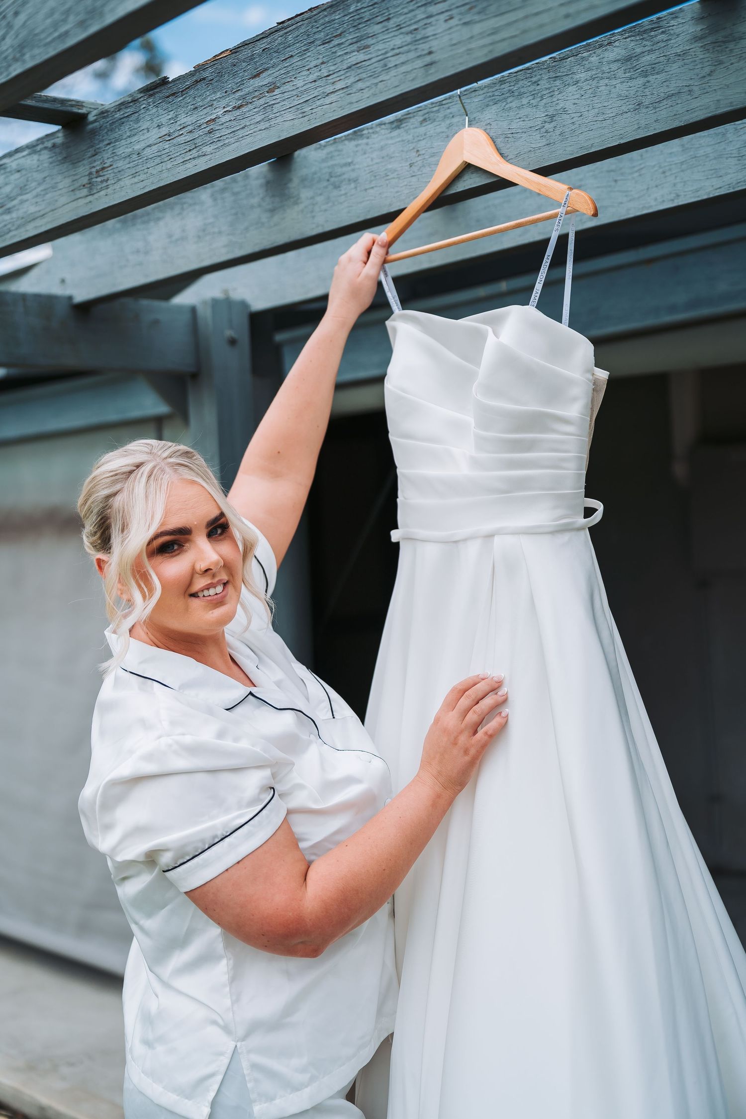 A white wedding dress hangs on display before the ceremony.