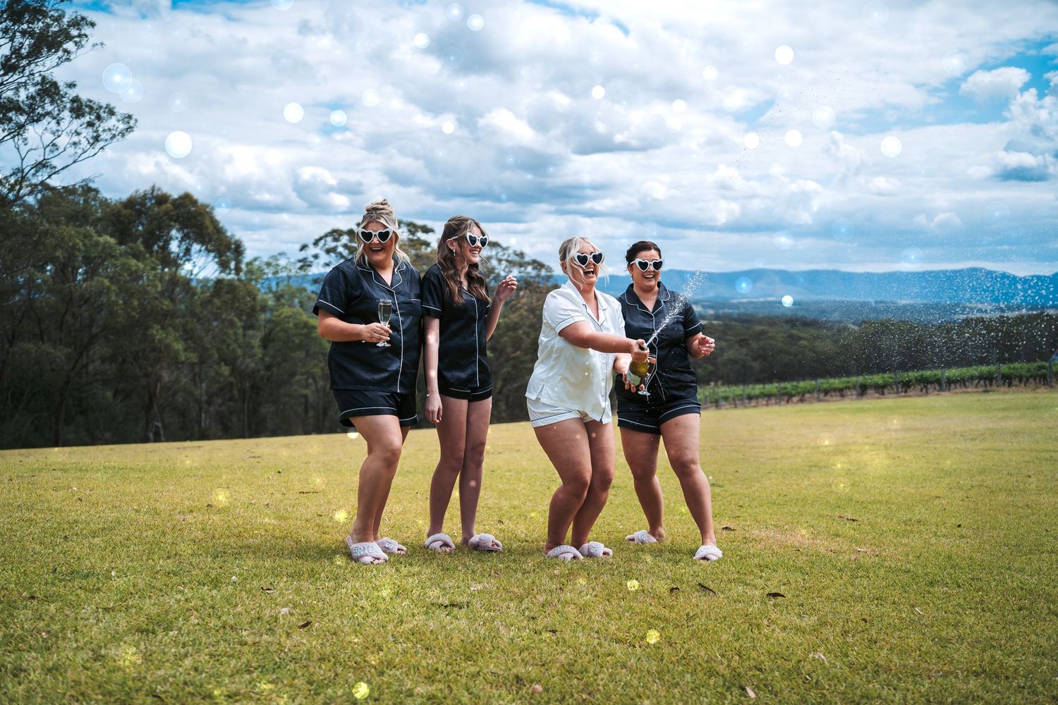 Group enjoying the outdoors against a backdrop of mountains and blue skies.