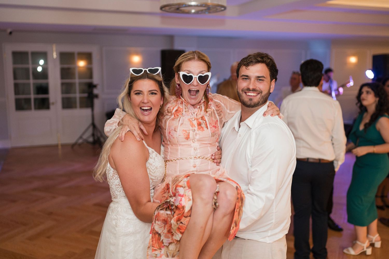 Joyful wedding party moment captured on the dance floor.