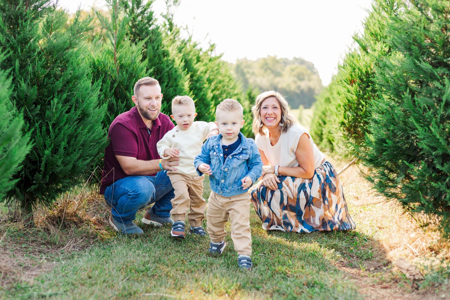 A family photo session among evergreen trees at sunset near Clemson, SC