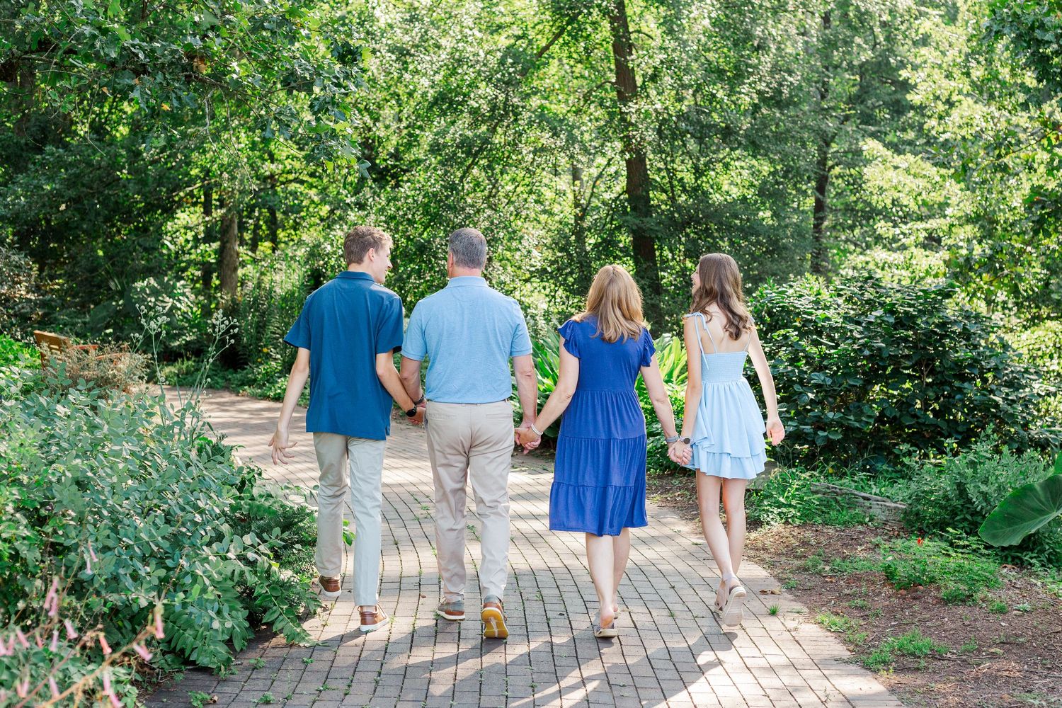 A family walks together for their photo session at the Botanical Gardens in Clemson, SC