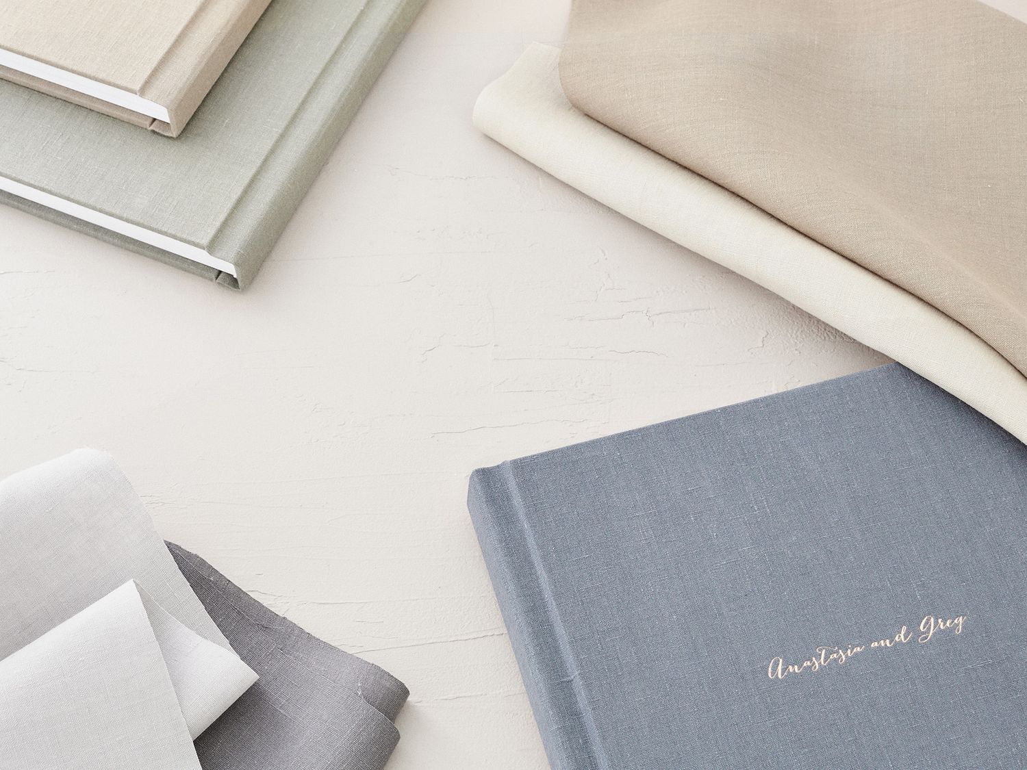A collection of minimalist gray and white stationery items arranged on a clean surface.