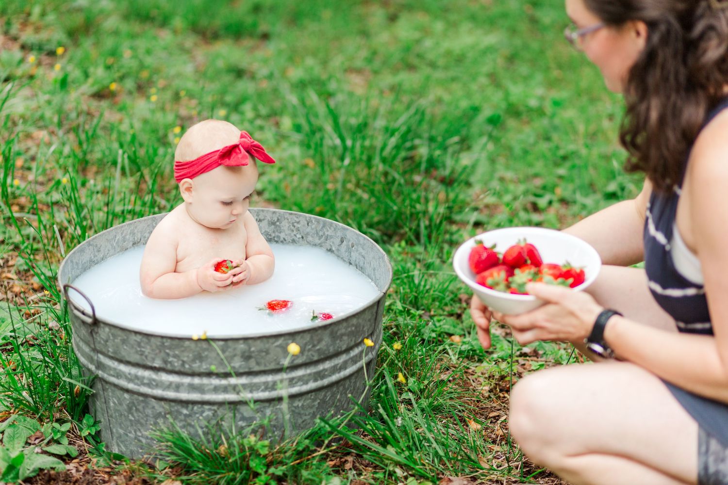 A series of images showing a baby playing in a vintage wash basin in Greenville, SC for milestone session