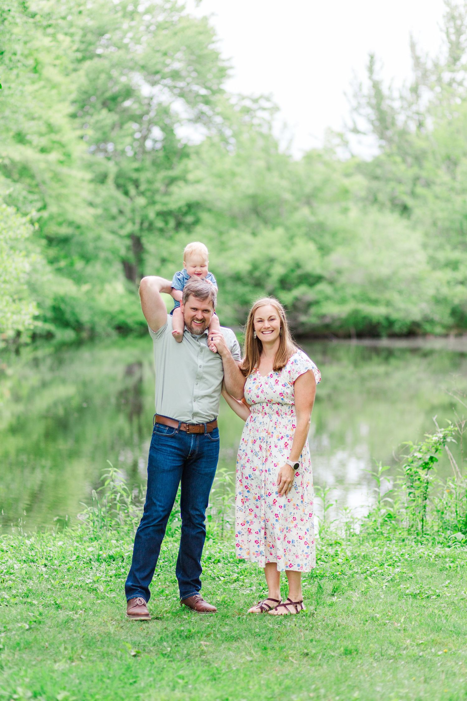 Playful scene in a park with spring flowers blooming for a family photo session in Hendersonville, NC taken by a Clemson, SC photographer.