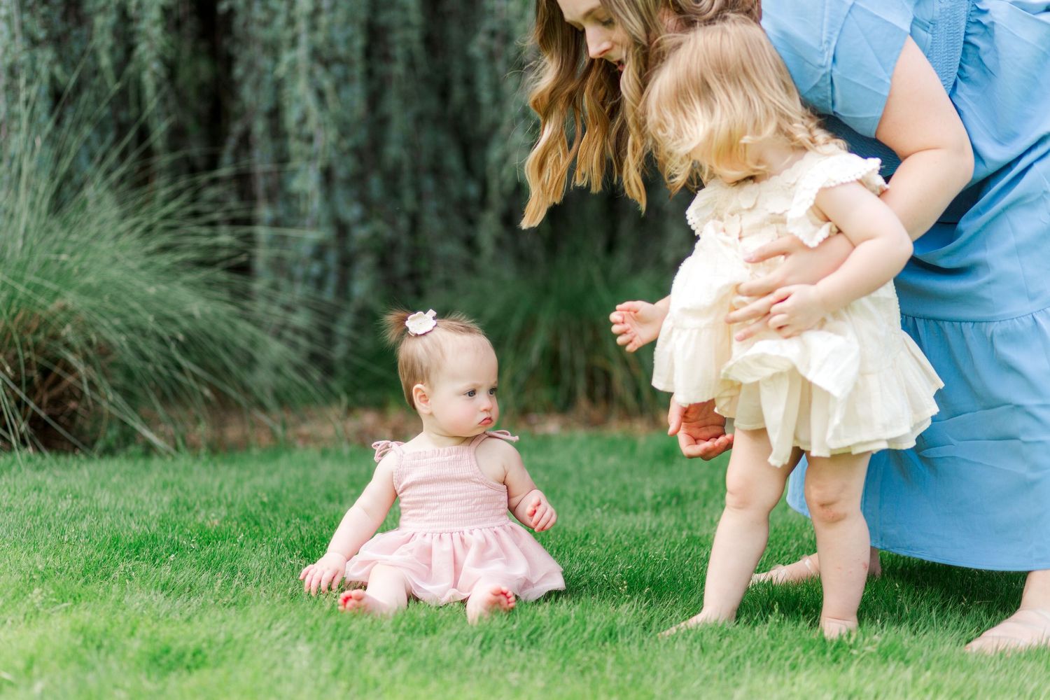 A series of family photos in Clemson, SC showing hands helping a small child for a family photo session.
