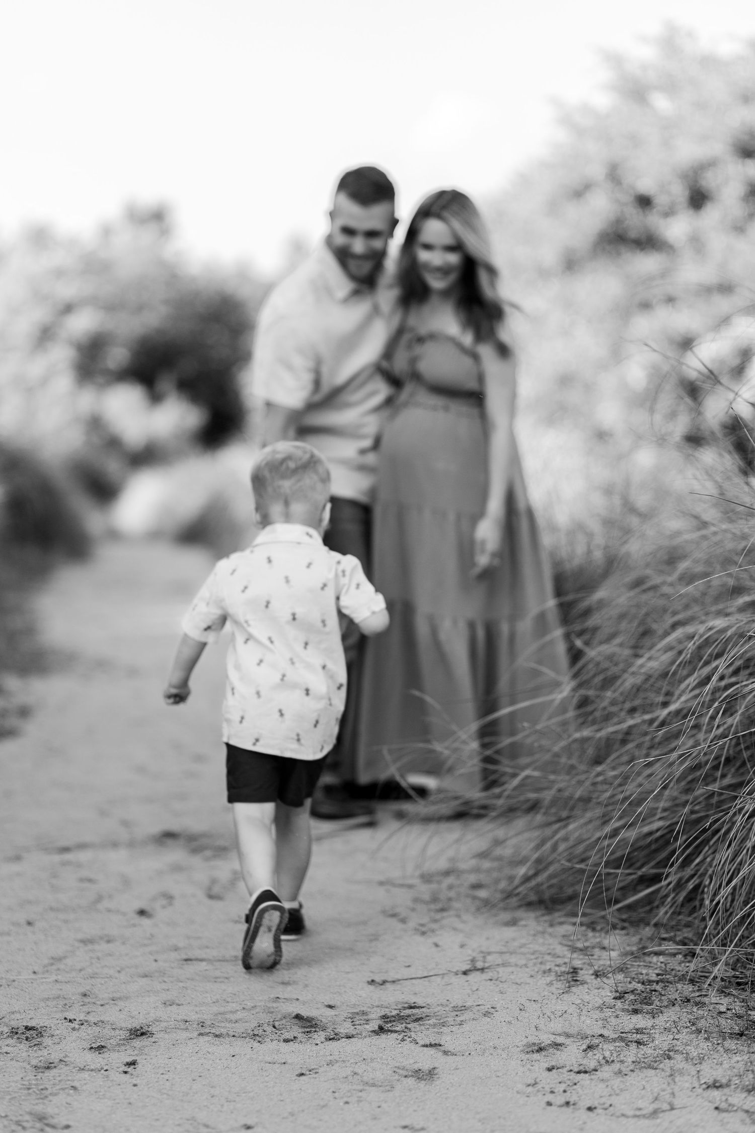 A child runs playfully in Clemson, SC for a family photo session