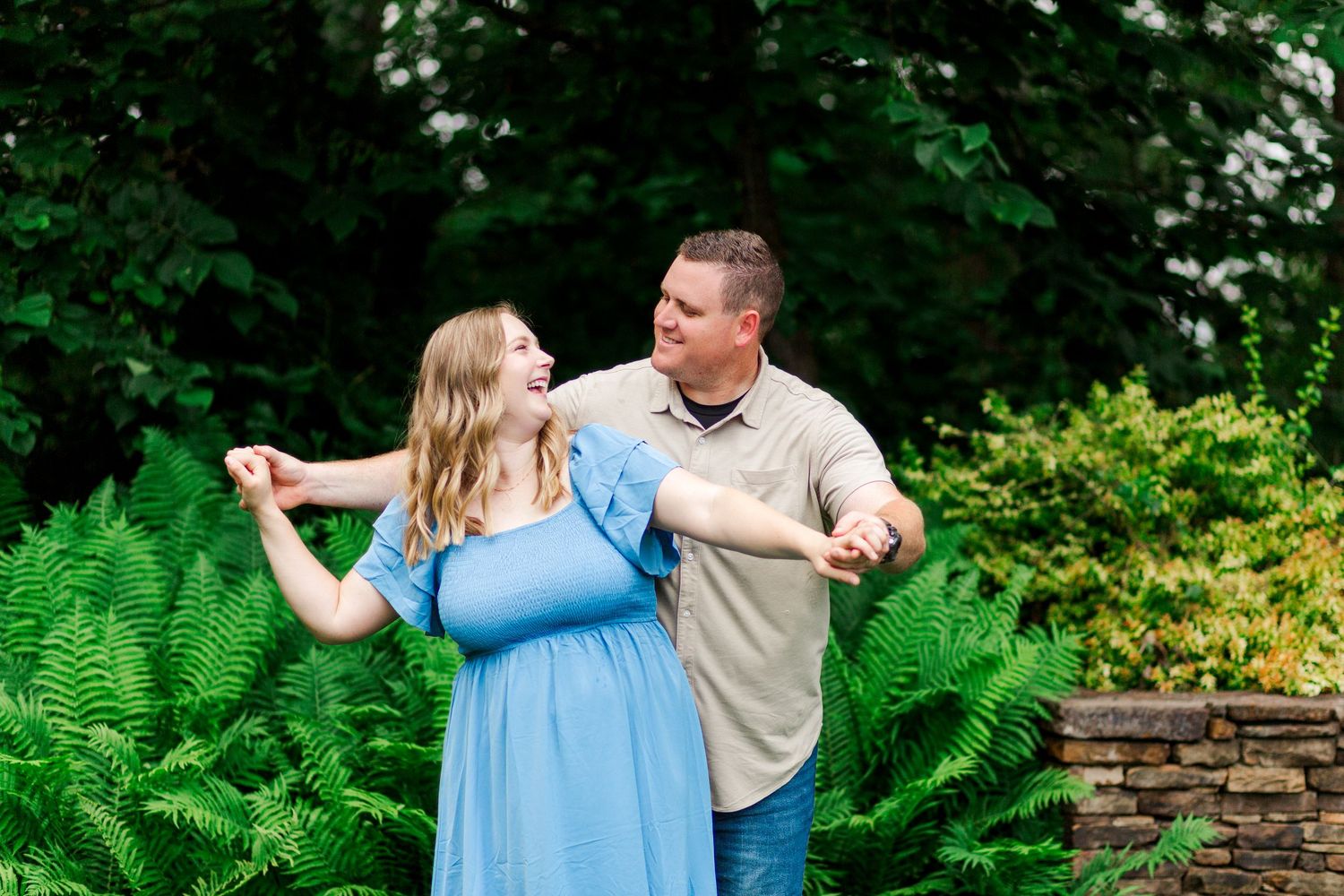 A couple poses for family photos at the Botanical Gardens in Clemson, SC