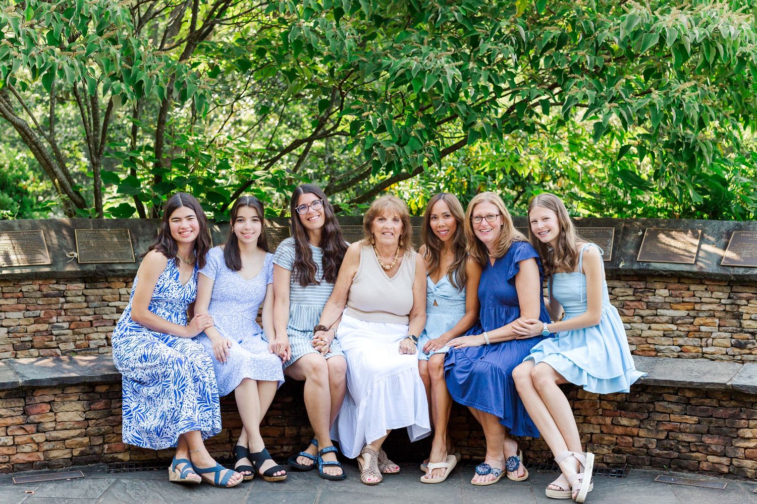 An extended family sits together for their family photo session at the Botanical Gardens in Clemson, SC.
