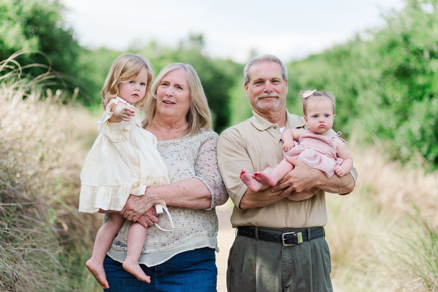 A series of candid family photographs taken in Clemson, SC in a sunny field with natural grass and vegetation.