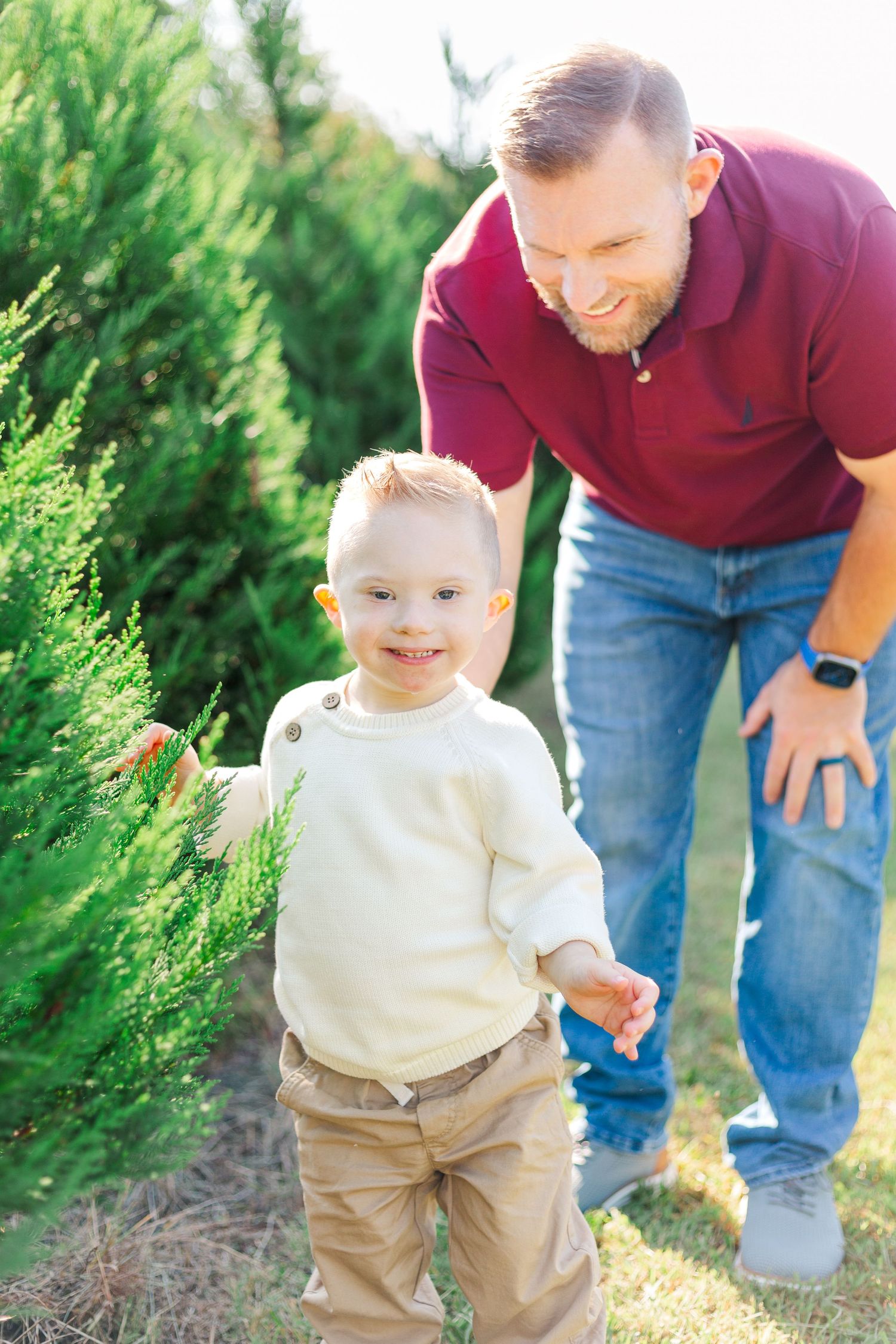 A series of candid shots showing a toddler in khaki pants and cream sweater playing outdoors with an adult in jeans.