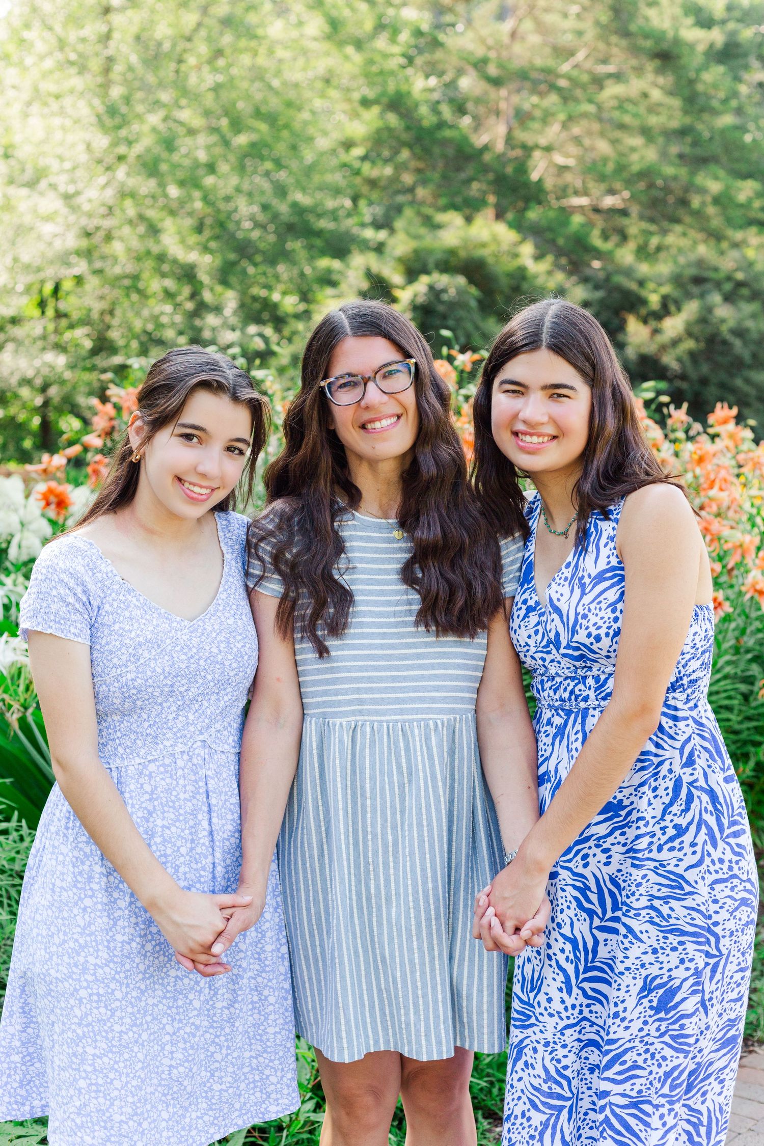 Three high school seniors in summer dresses pose together in at the Botanical Gardens in Clemson, SC