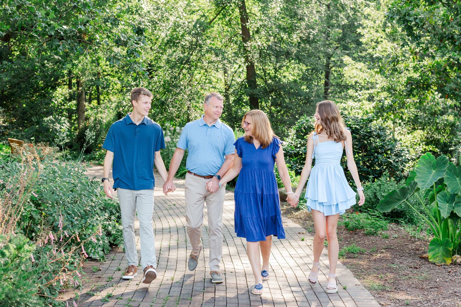 Family walks together at the Botanical Gardens in Clemson, SC for their summer family photo session.
