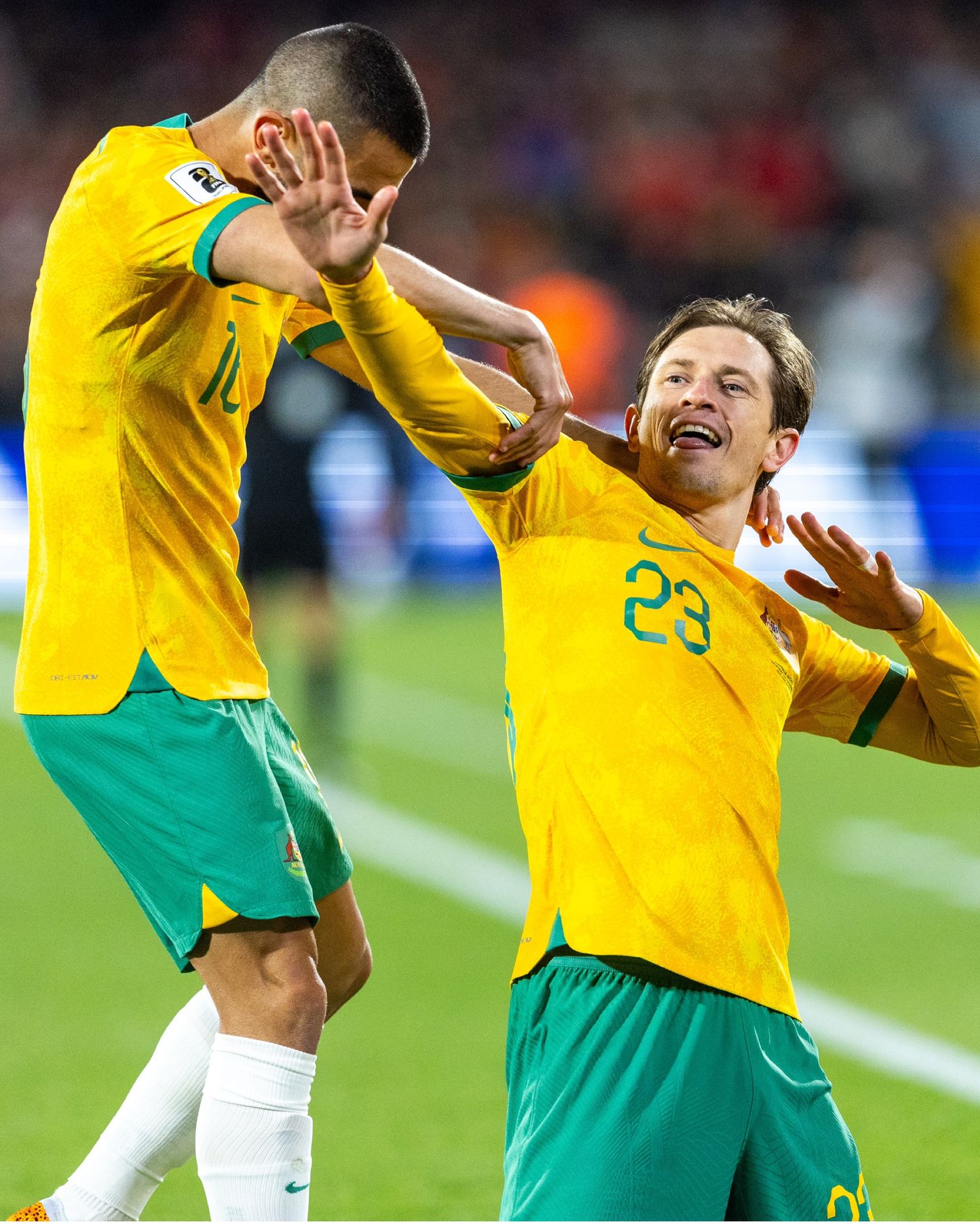 Soccer players in yellow and green uniforms celebrate during an intense match.