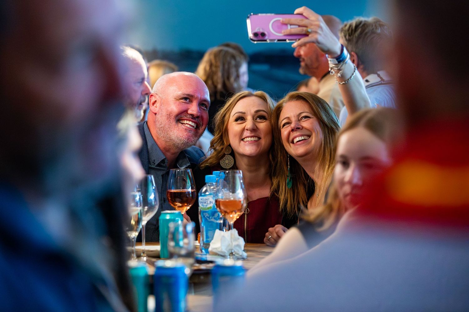 People enjoying a social gathering at a dimly lit restaurant or bar.