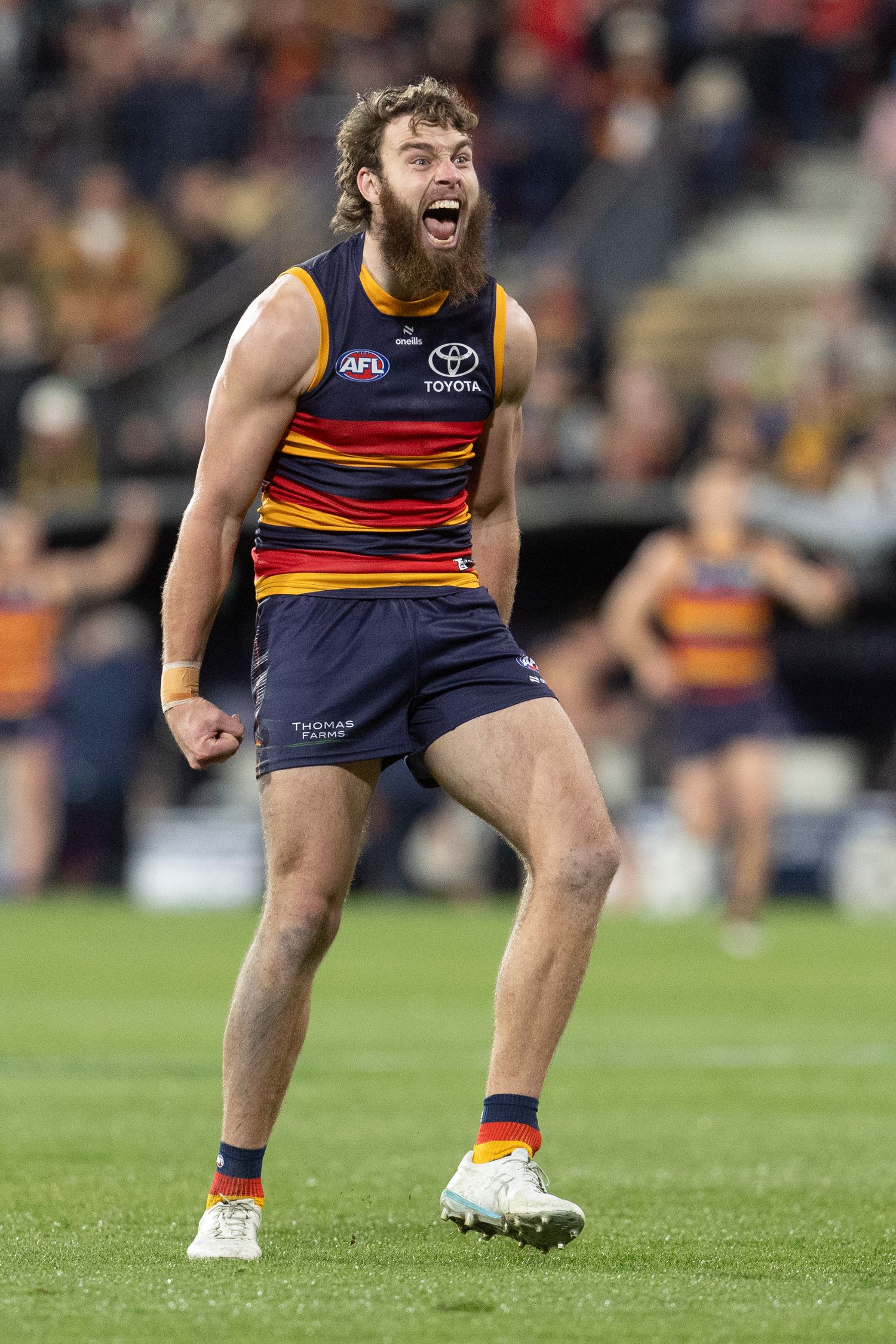 Close-up sequence showing a player's feet in AFL team uniform and boots on a sports field.
