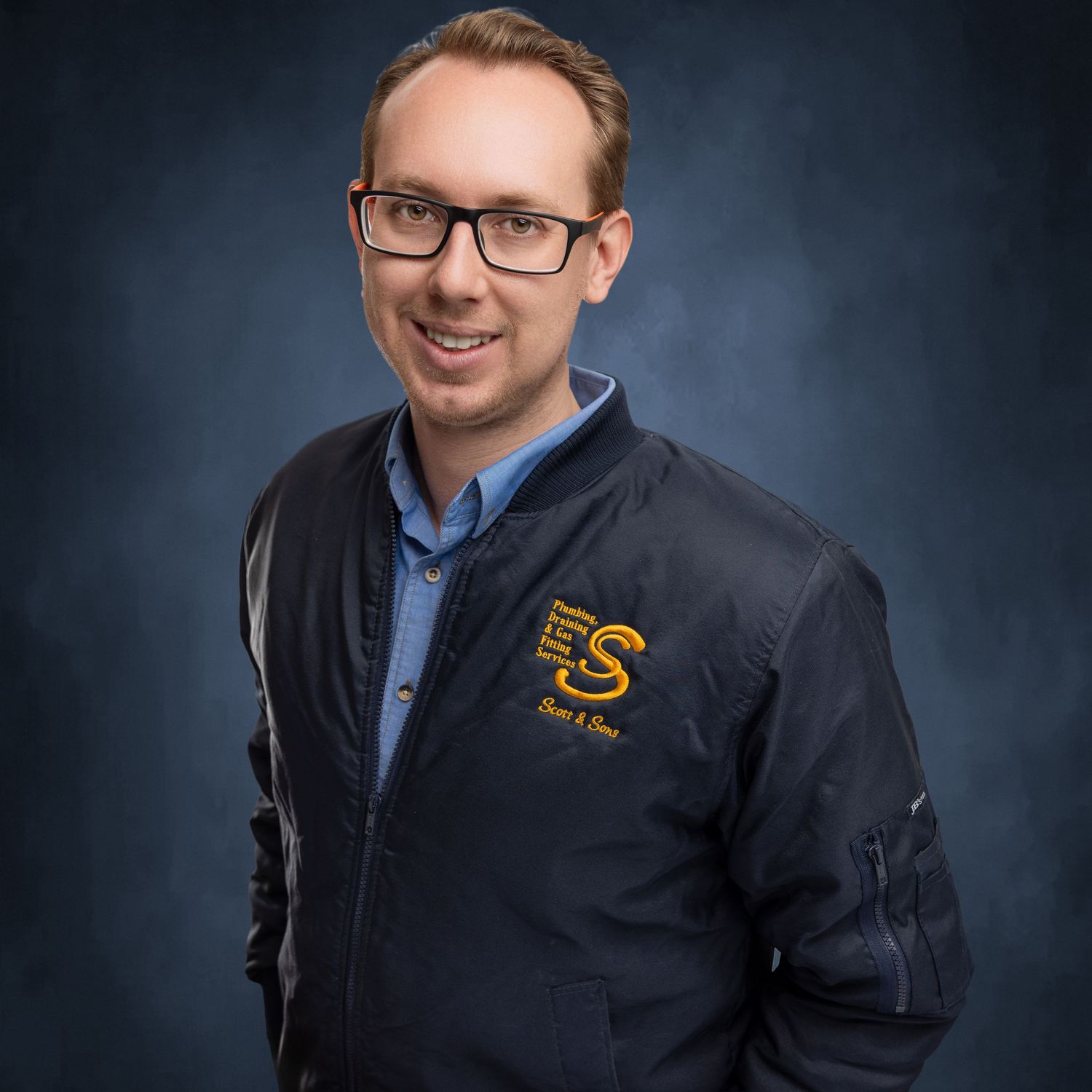 Professional portraits of person in navy uniform with embroidered logo.