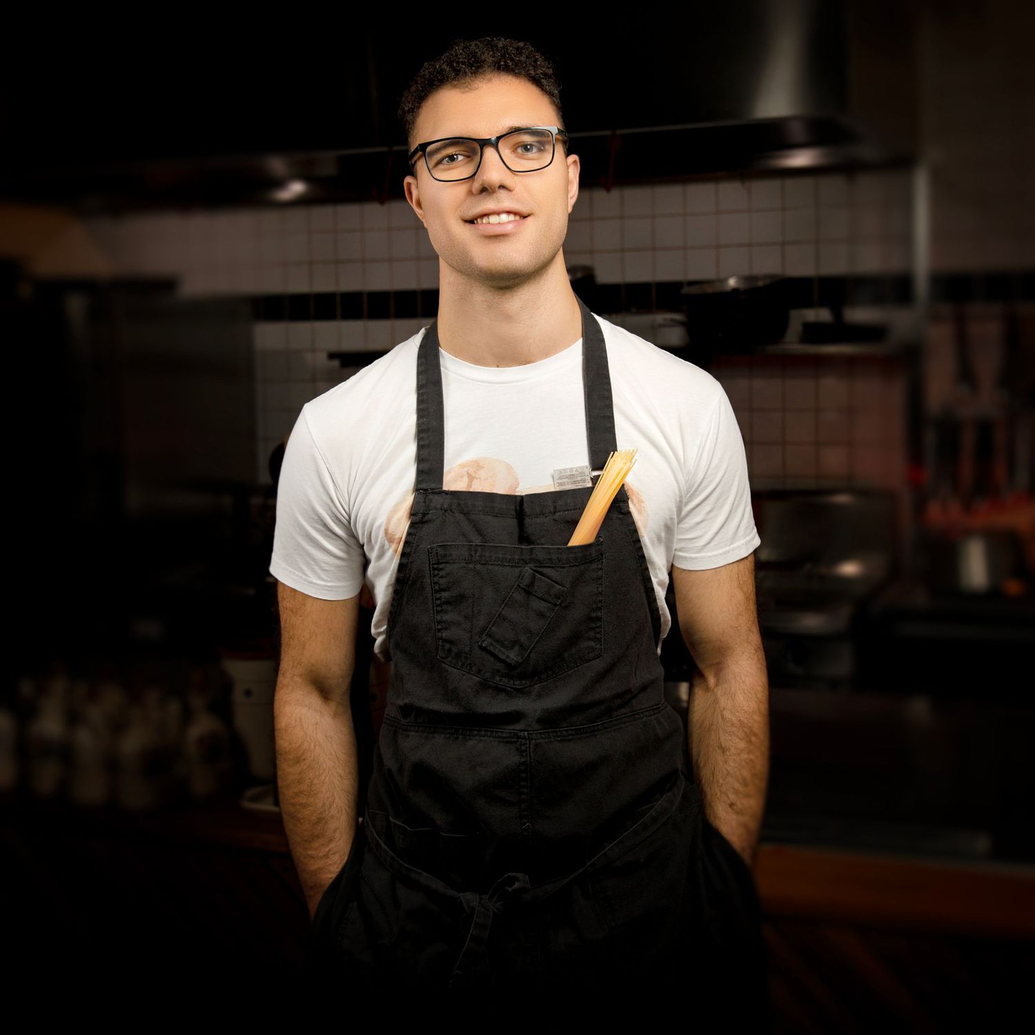 Restaurant staff portrait photography showing chef in apron, captured in warm Sydney hospitality setting.