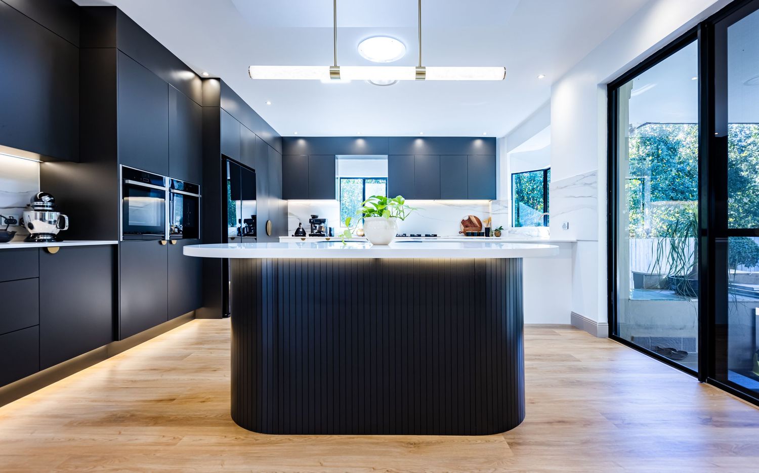 Modern office interior featuring black walls, skylights and minimalist design elements.