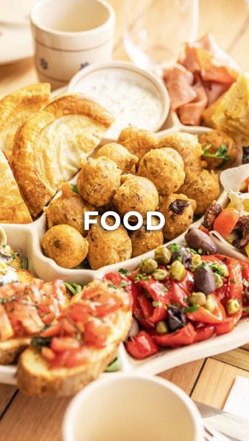 Appetizing platter of golden fried meatballs served alongside colorful bruschetta with fresh tomatoes and herbs.