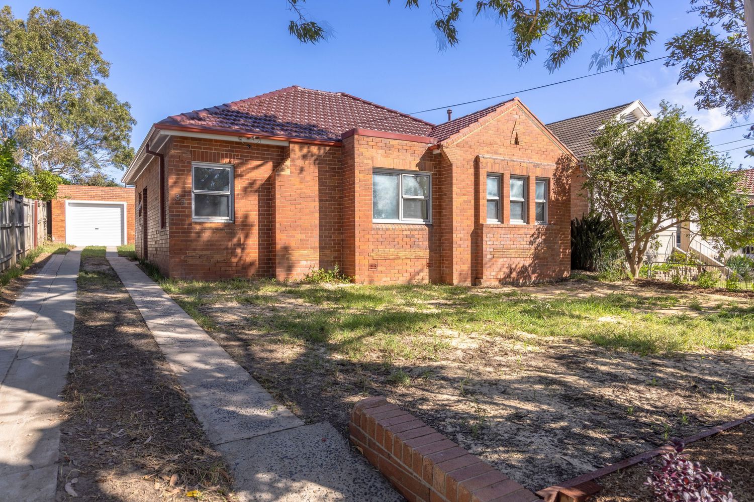 A brick ranch-style home with multiple exterior views showing landscaping and driveways on a sunny day.