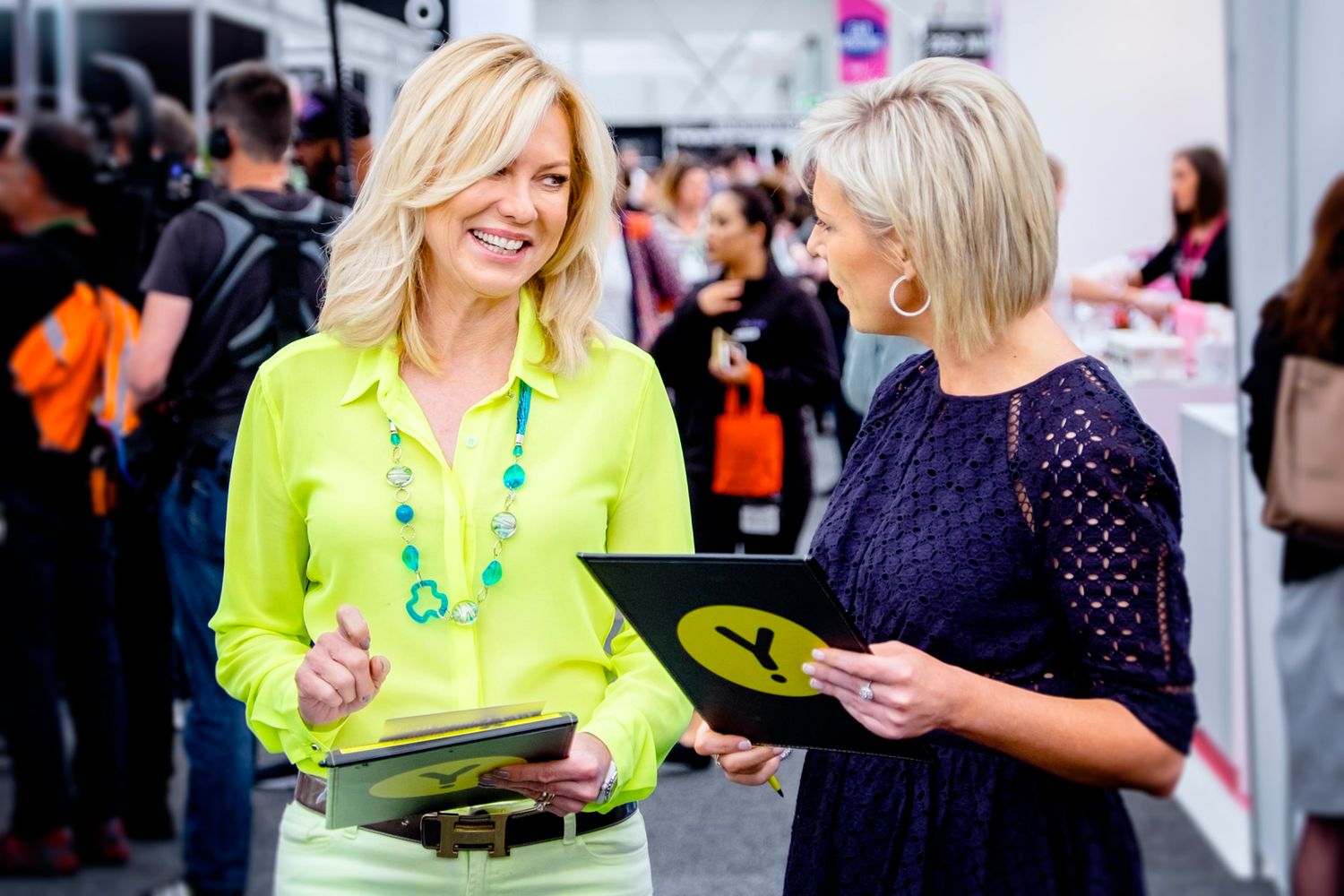 Event attendees in business attire networking at a corporate function.