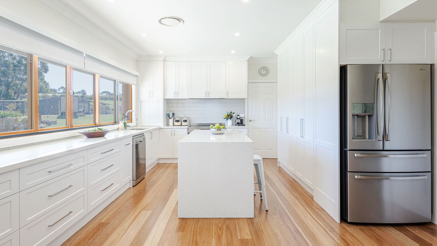 Modern white kitchen with stainless steel appliances and clean lines shown in a 360-degree panoramic view.