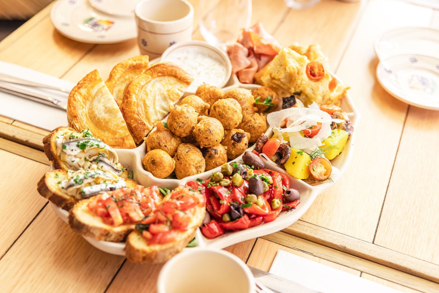 Gourmet restaurant plates featuring artfully presented dishes with colorful garnishes and sauces.