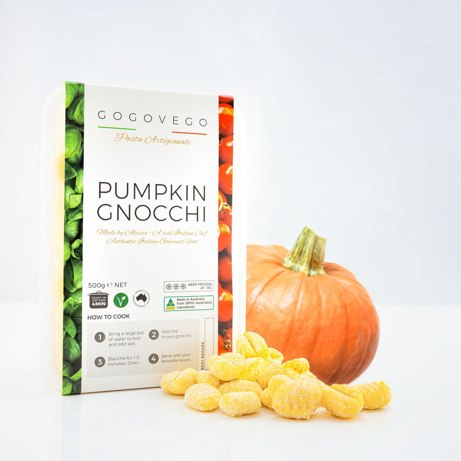 Pumpkin gnocchi product display with fresh pumpkin and pasta pieces on white background.