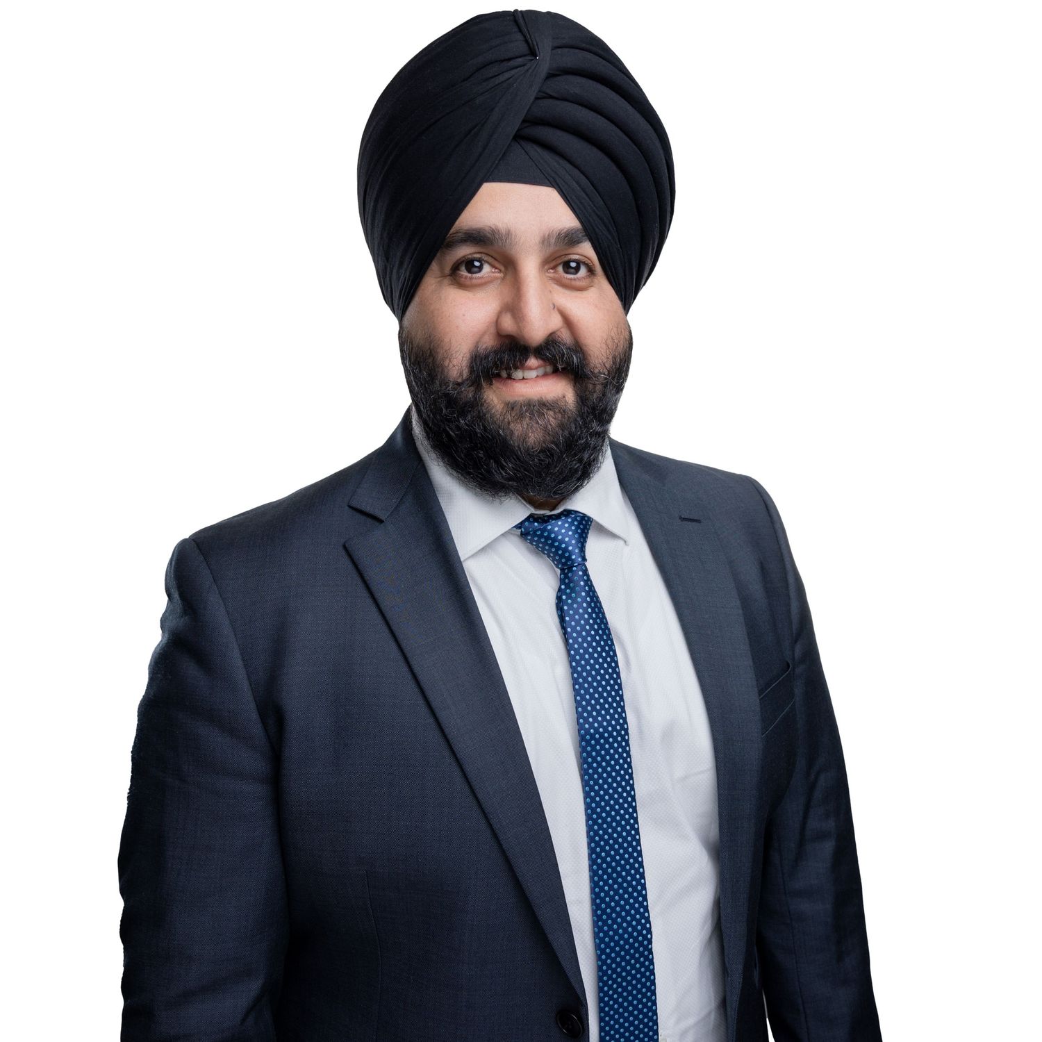 Professional in navy suit and blue tie with turban poses in multiple angles.