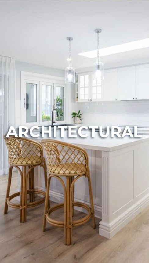 Modern white kitchen with bamboo rattan counter stools and hardwood flooring showcases clean architectural design.