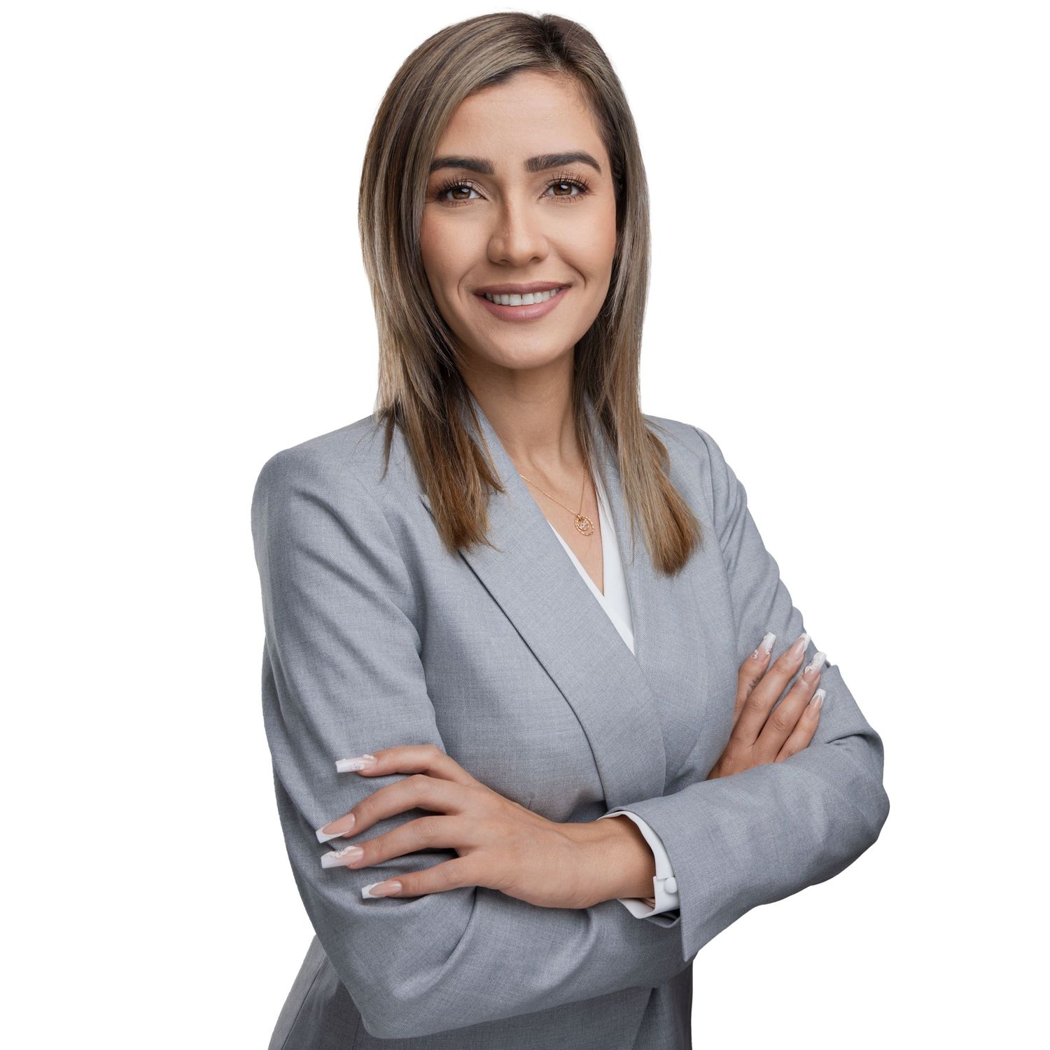 Professional businesswoman in gray suit jacket poses with confident crossed arms against white background.